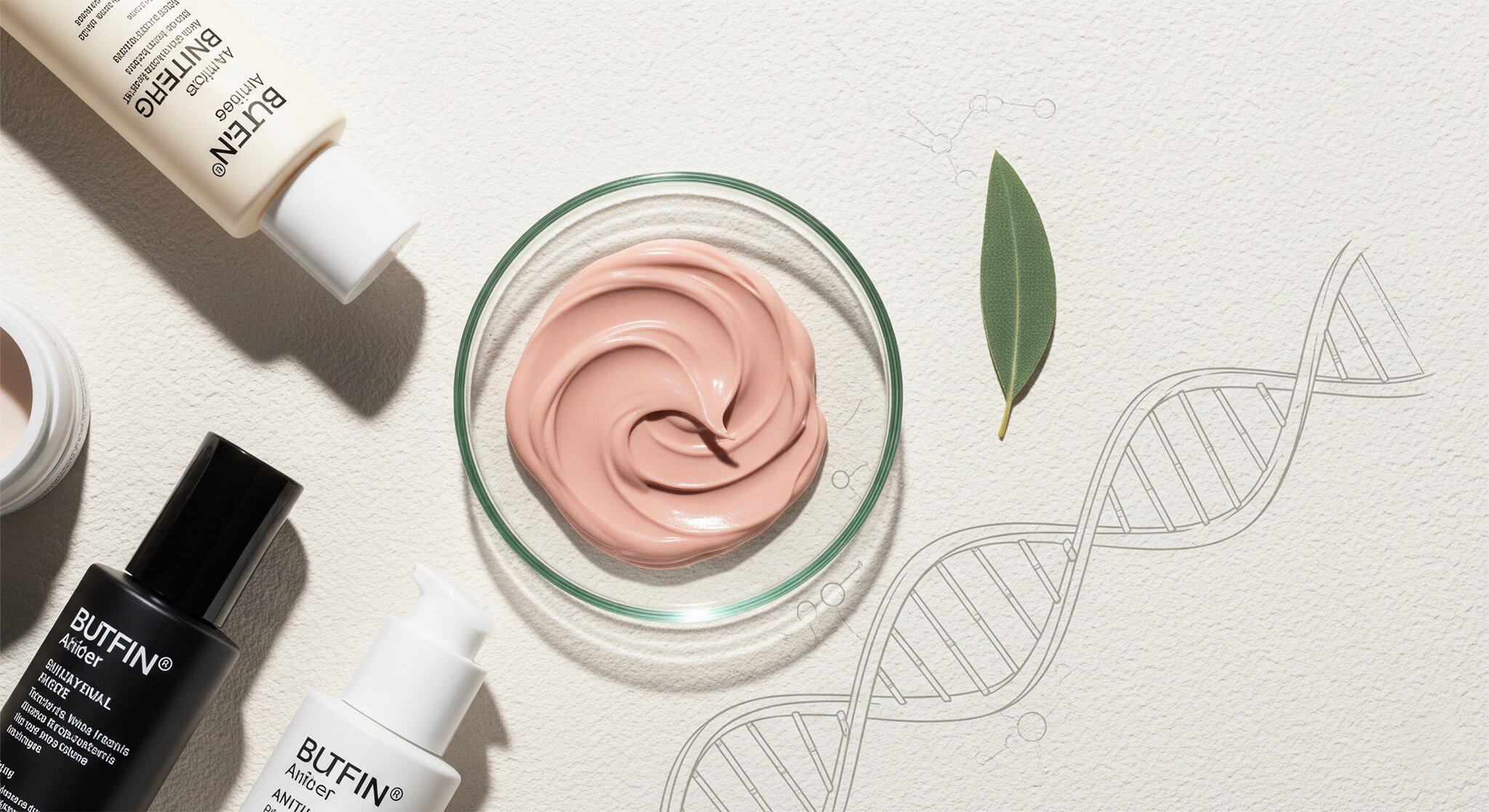A flat-lay of anti-aging skincare products, including cream and charcoal bottles, a petri dish with dusty rose-colored cream, and a sage green leaf, arranged on a cream background with a DNA helix illustration.