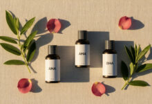 Alt Text: A serene flat lay of minimalist skincare bottles representing the best chemical exfoliants, AHA and BHA, for a hormonal skincare routine tailored to different menstrual cycle phases.