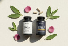 Alt Text: A minimalist flat lay of Biotin and Omega-3 supplement bottles, ranked as the best for reducing a dry scalp and promoting overall scalp health for stronger, healthier hair.