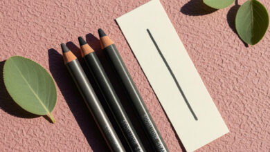 A review of the best no-tug eyeliner pencils, showing three products and a smooth swatch that demonstrates a gentle glide suitable for mature eyelids.