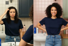 image showing the different effects of silicone-based products on frizzy hair. On the left, a woman with dark, curly hair looks in a mirror with a sad and confused expression, touching her hair which appears weighed-down and greasy. The bathroom has cream and charcoal tones. On the right, the same woman has beautifully defined, frizz-free curls and a confident, happy smile, with her hands on her hips. The bathroom on this side has a fresh feel with dusty rose and sage green colors.