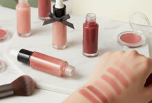 A collection of the best liquid blushes in various shades, with swatches on an arm demonstrating their natural and long-lasting color on a marble surface.