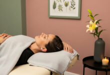 Woman undergoing acupuncture treatment, with needles gently placed on her scalp, in a tranquil room with dusty rose and sage green walls, suggesting relief for seasonal hair loss.