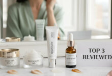 A reflection of a woman in a mirror above a vanity with three different retinol eye creams and a "TOP 3 REVIEWED" sign, showcasing the best retinol eye creams.