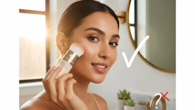 A gorgeous woman in a well-lit bathroom applies Colorescience powder SPF with a built-in brush, demonstrating its application and addressing whether powder SPFs provide real protection.