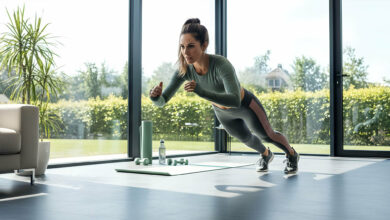 A dynamic woman performs a high-intensity exercise in a bright, modern home gym with expansive windows.