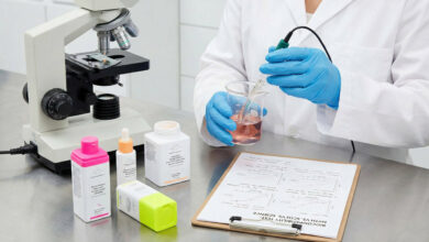 A scientist testing Drunk Elephant skincare products in a laboratory setting using scientific equipment.