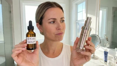 A woman skeptically comparing a bottle labeled "$15.00 SERUM" against a high-end luxury skincare bottle in a bright bathroom, illustrating a budget versus luxury product comparison